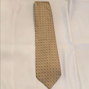 Bernini tie. Goldish beige with small red dots.